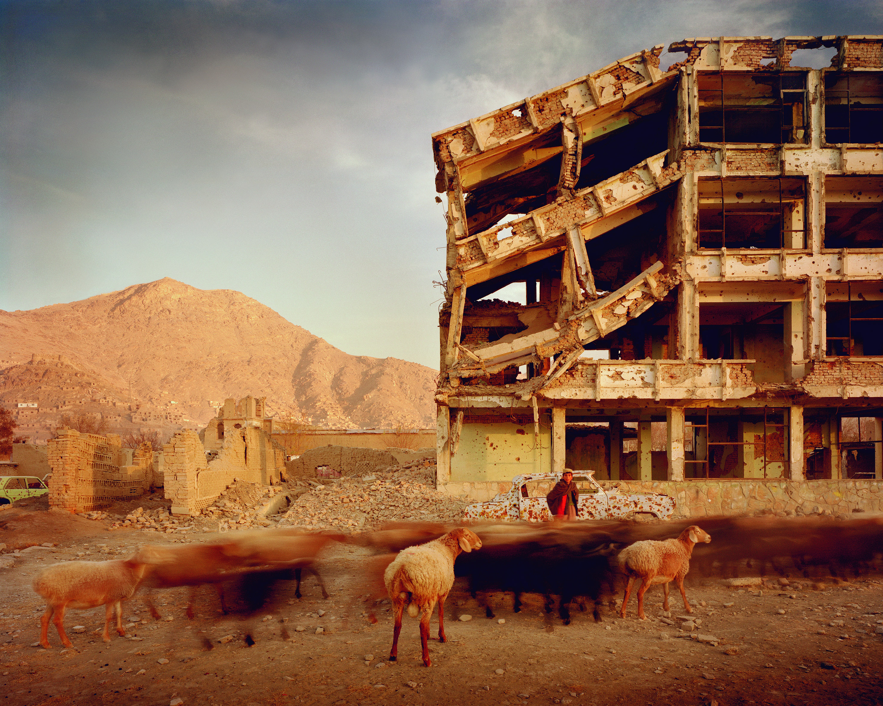 Simon Norfolk Bullet-scarred apartment building and shops in the Karte Char district of Kabul. This area saw fighting between Hikmetyar and Rabbani and then between Rabbani and the Hazaras 2003 © Simon Norfolk