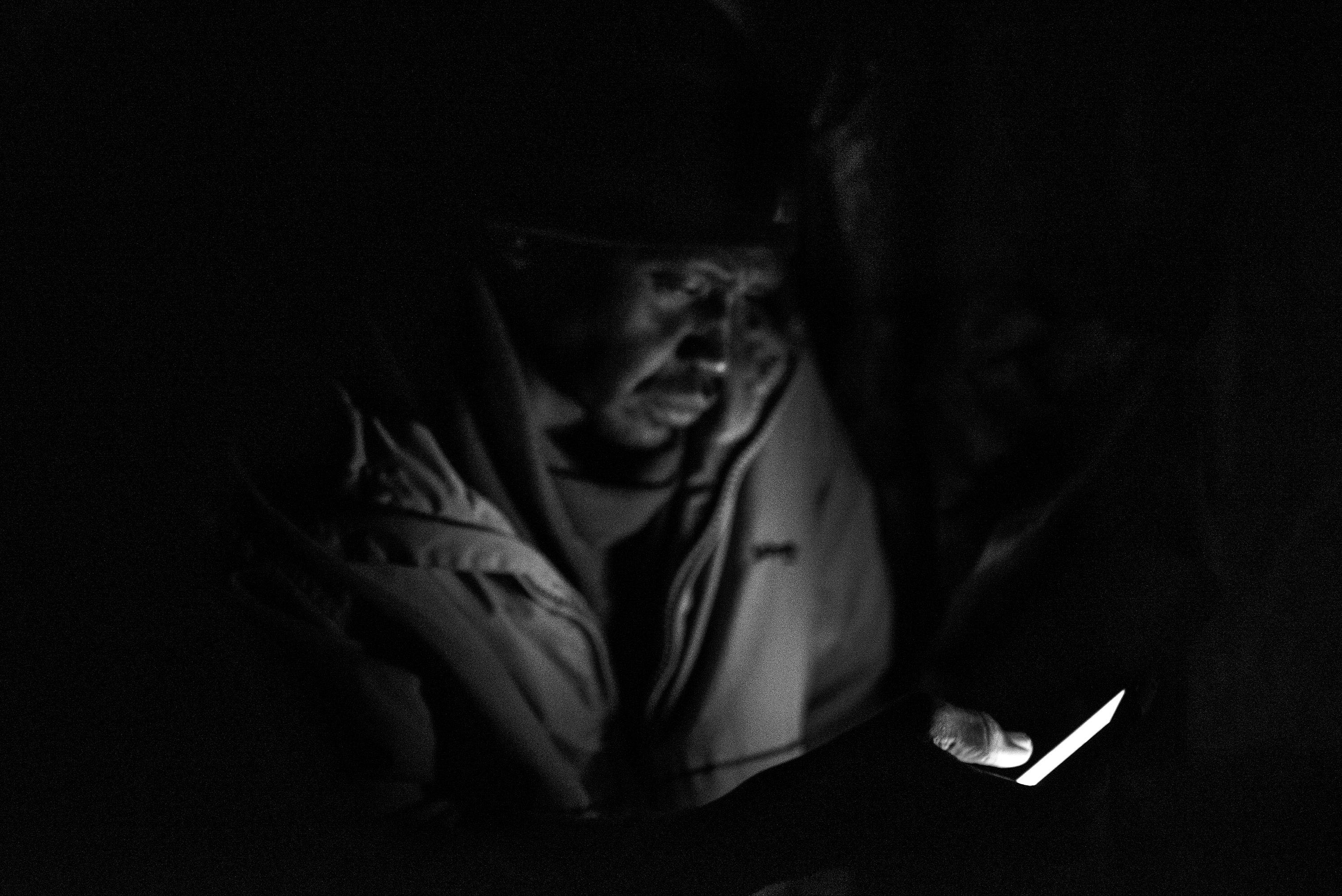 In the evening Ahmad stays in his shelter, using his phone to speak with relatives and friends.