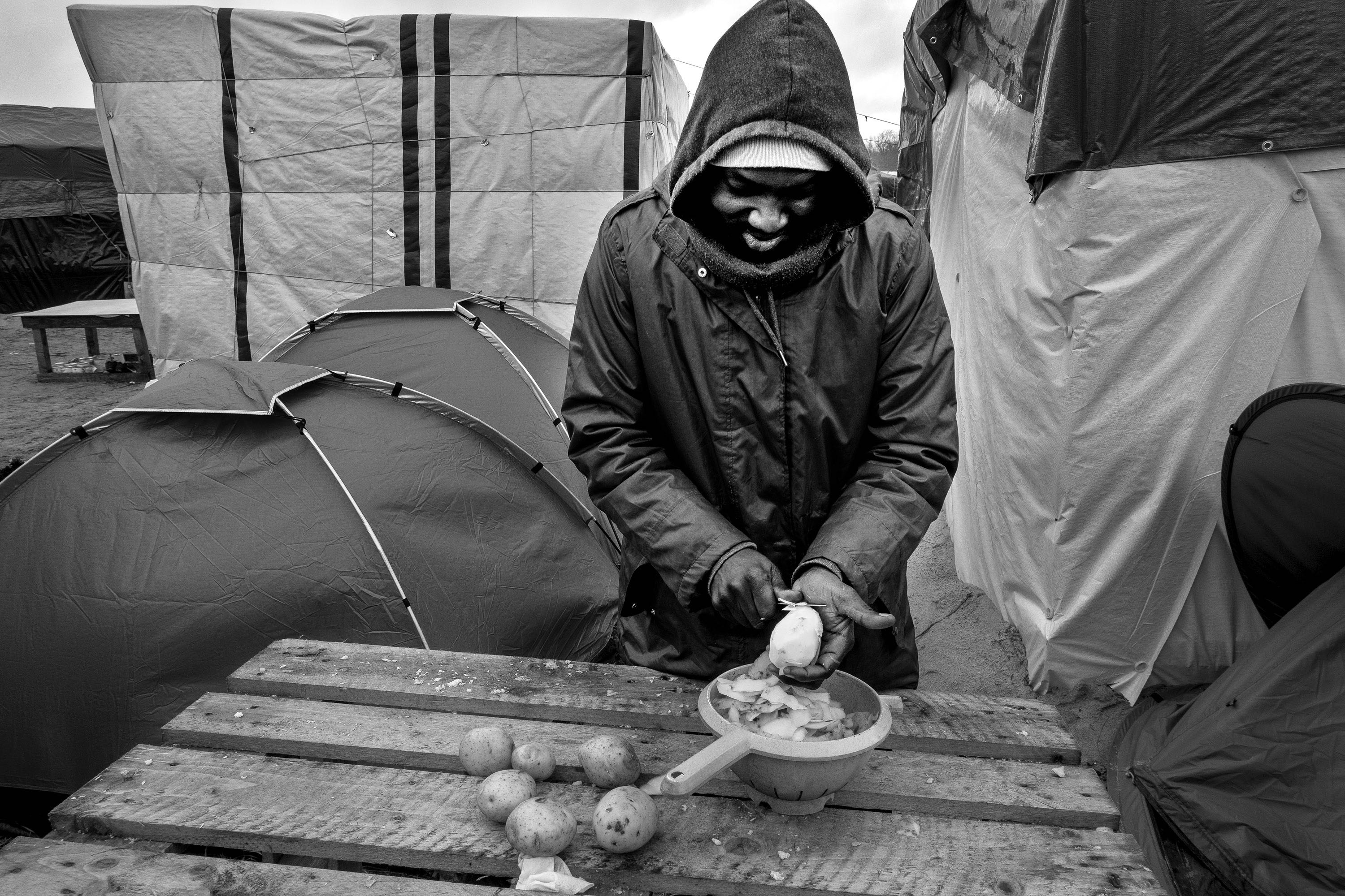 Gibril, 28 years old, peels potatoes for lunch. The Zaghawa of Sudan - Maurizio Martorana #6