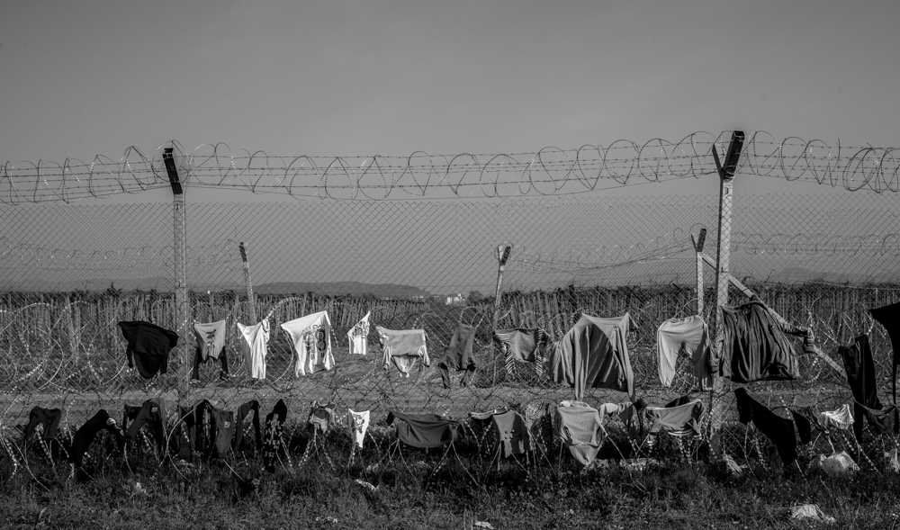 The border fence between Greece and Macedonia from the Greek side in the small village of Idomeni. Migrants who have gathered here hoping to be able to pass through and on to Germany are using the fence to hang out washing.