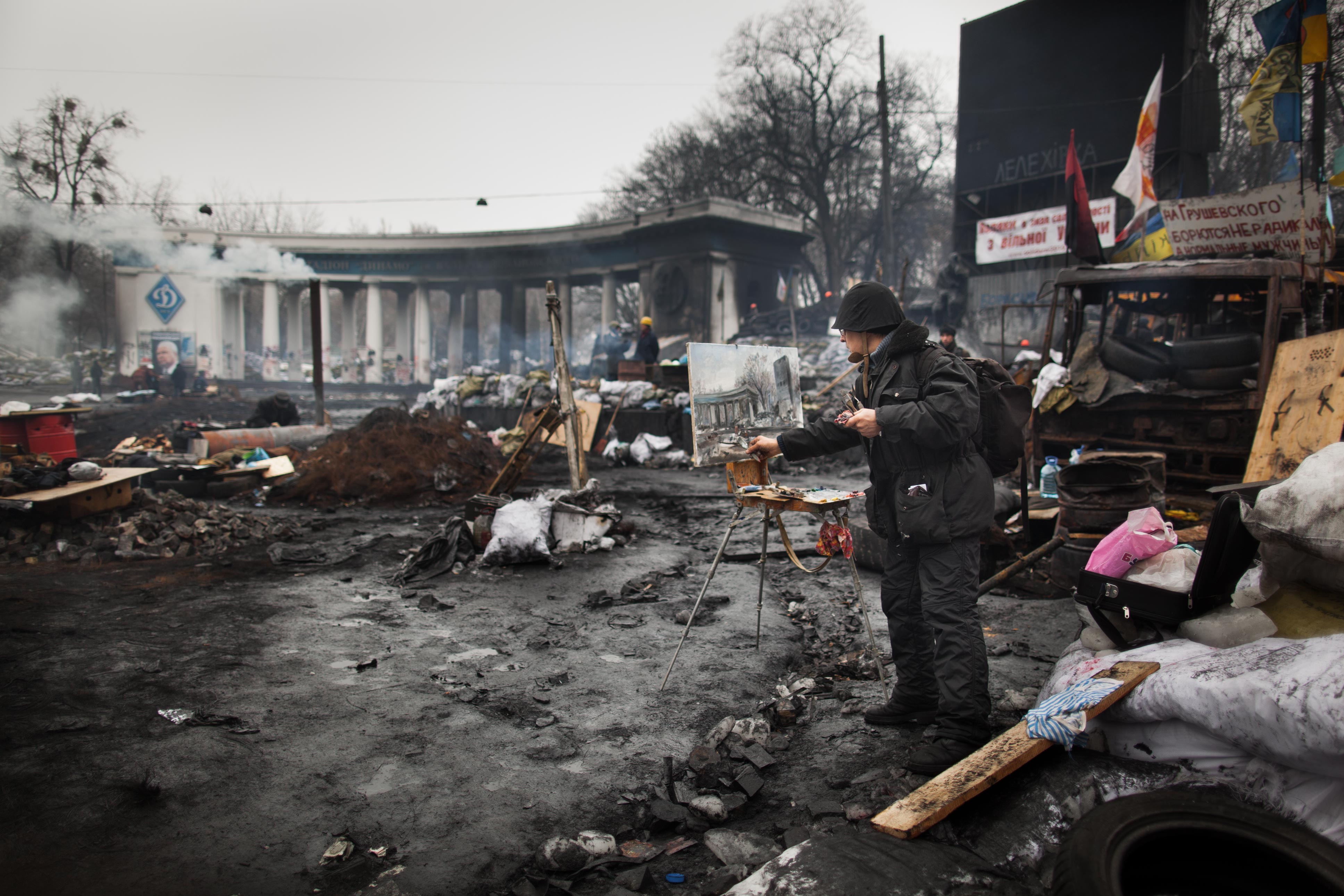 An artist paints during Ukraine’s Maidan protests, February 2014.