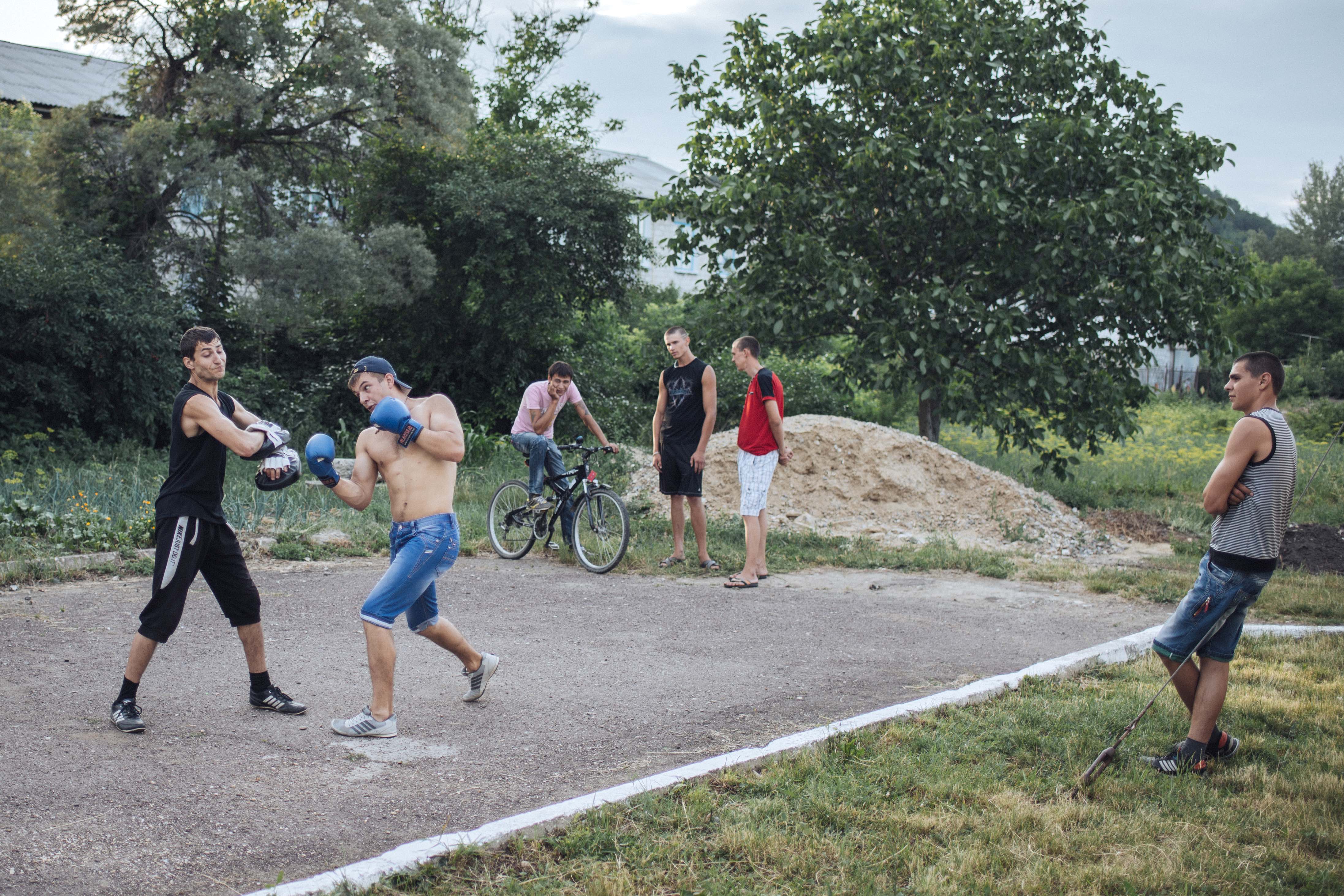 Young men hang out in Camenca. They come to its stadium several times a week to work out in preparation for military service or simply just to stay active.