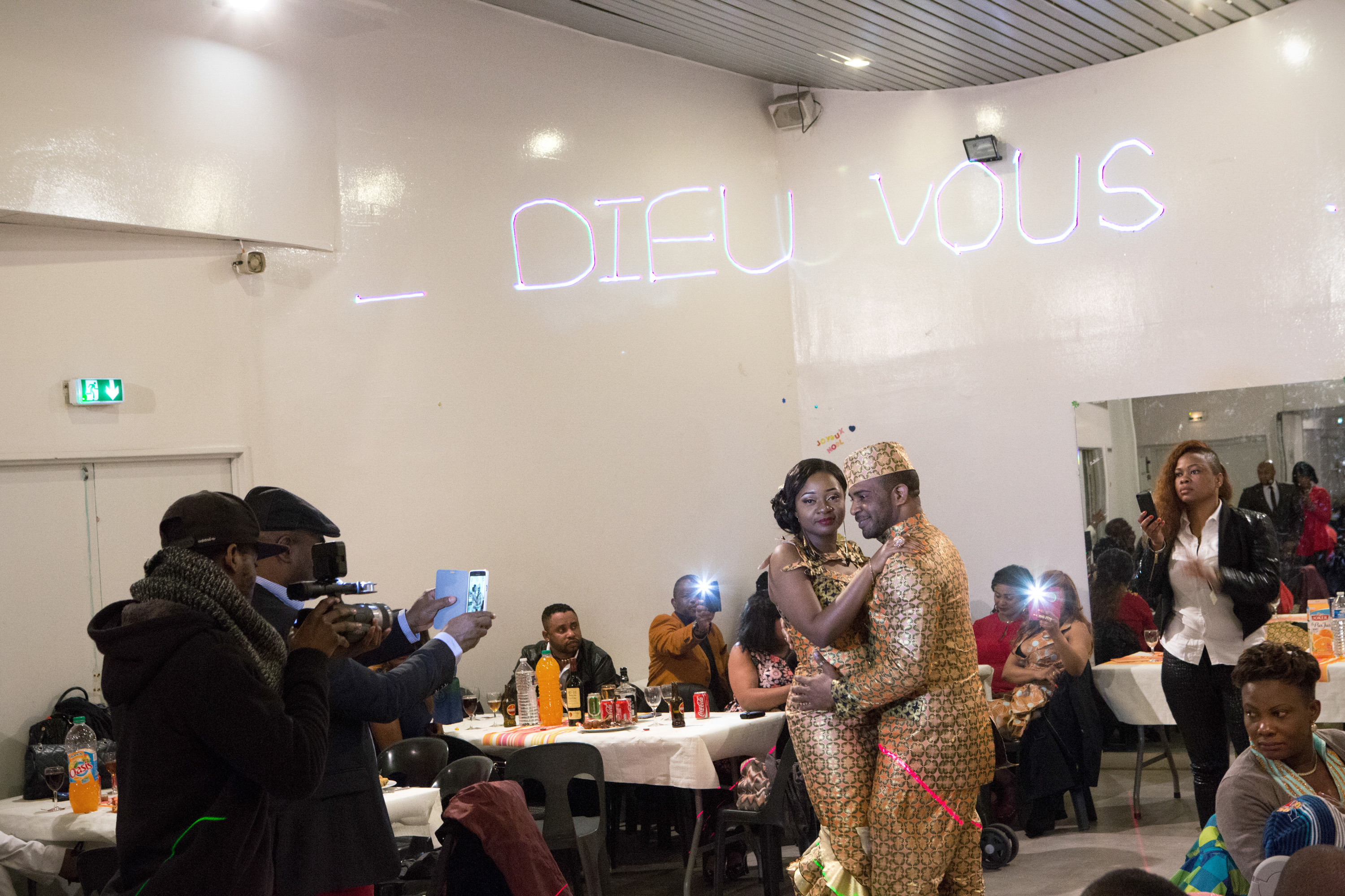 Carine Mwanza dances with her husband celebrating their traditional marriage and dowry. Sarcelles, Ile de France, France,2015. From the series ‘First Generation’ © Carolina Arantes