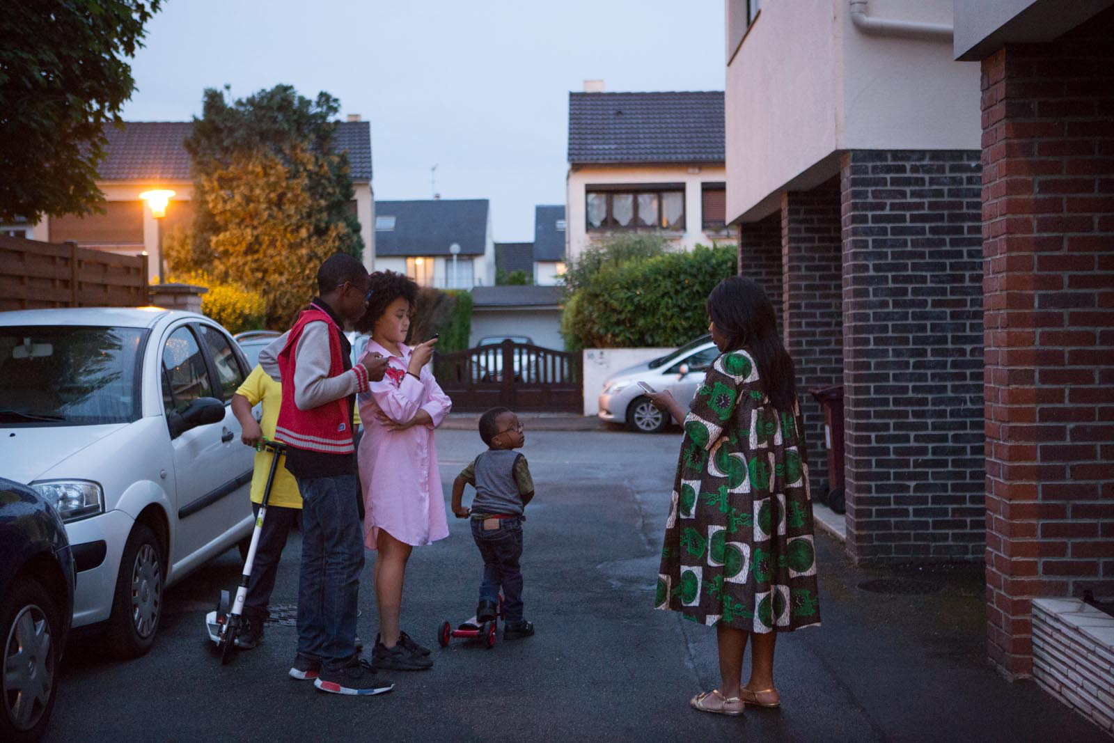 Corinne Kyoto Sy and kids in front of her house during the mourning of her father.Livry-Gargan, Ile de France, France From the series ‘First Generation’ © Carolina Arantes