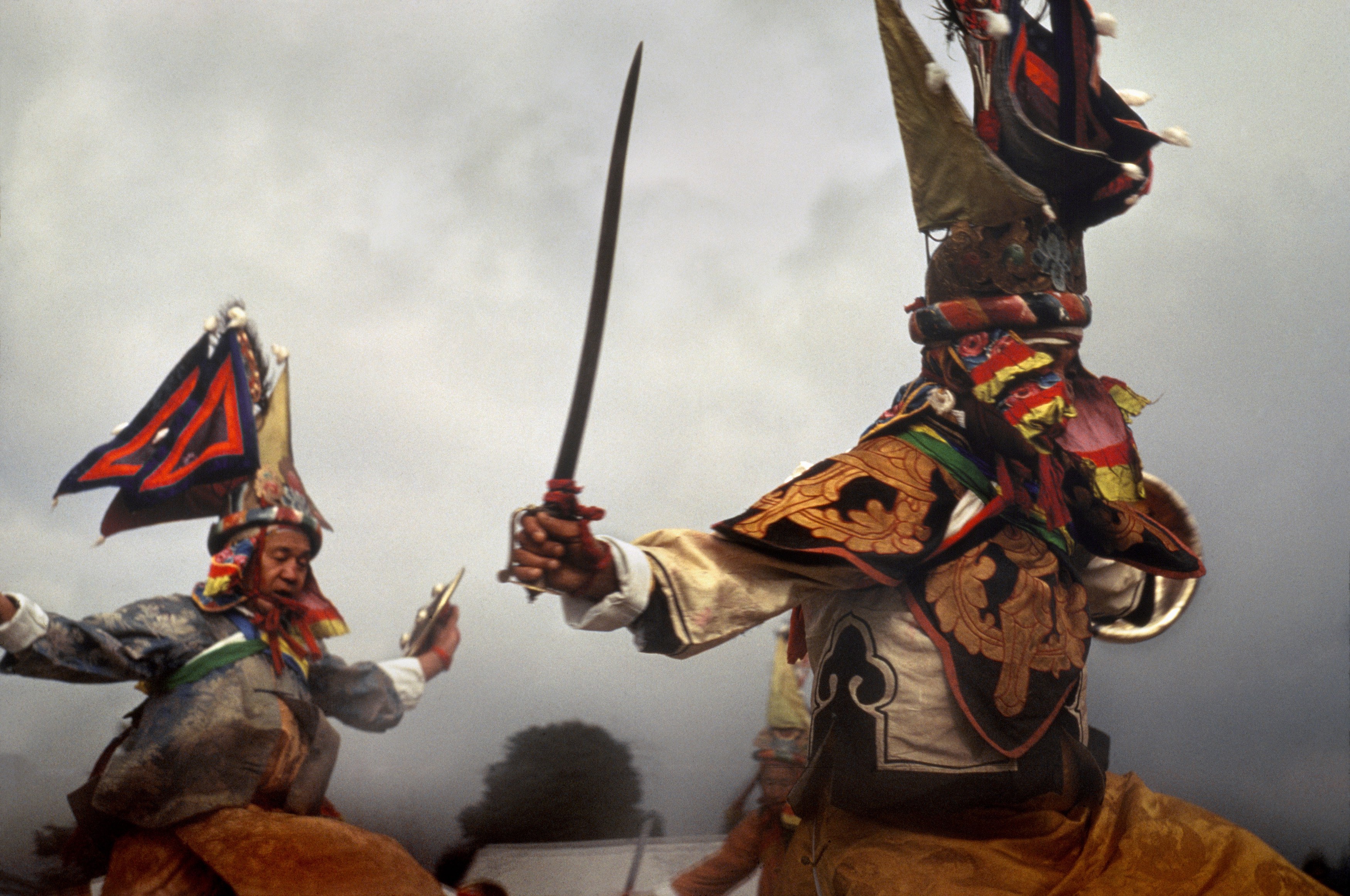 Warrior dancers, attendants of the sacred Mt. Kangchenjunga and defenders of the Dharma, during the Sikkimese New Year dances. Gangtok, Sikkim. 1968 © Marilyn Silverstone / Magnum Photos