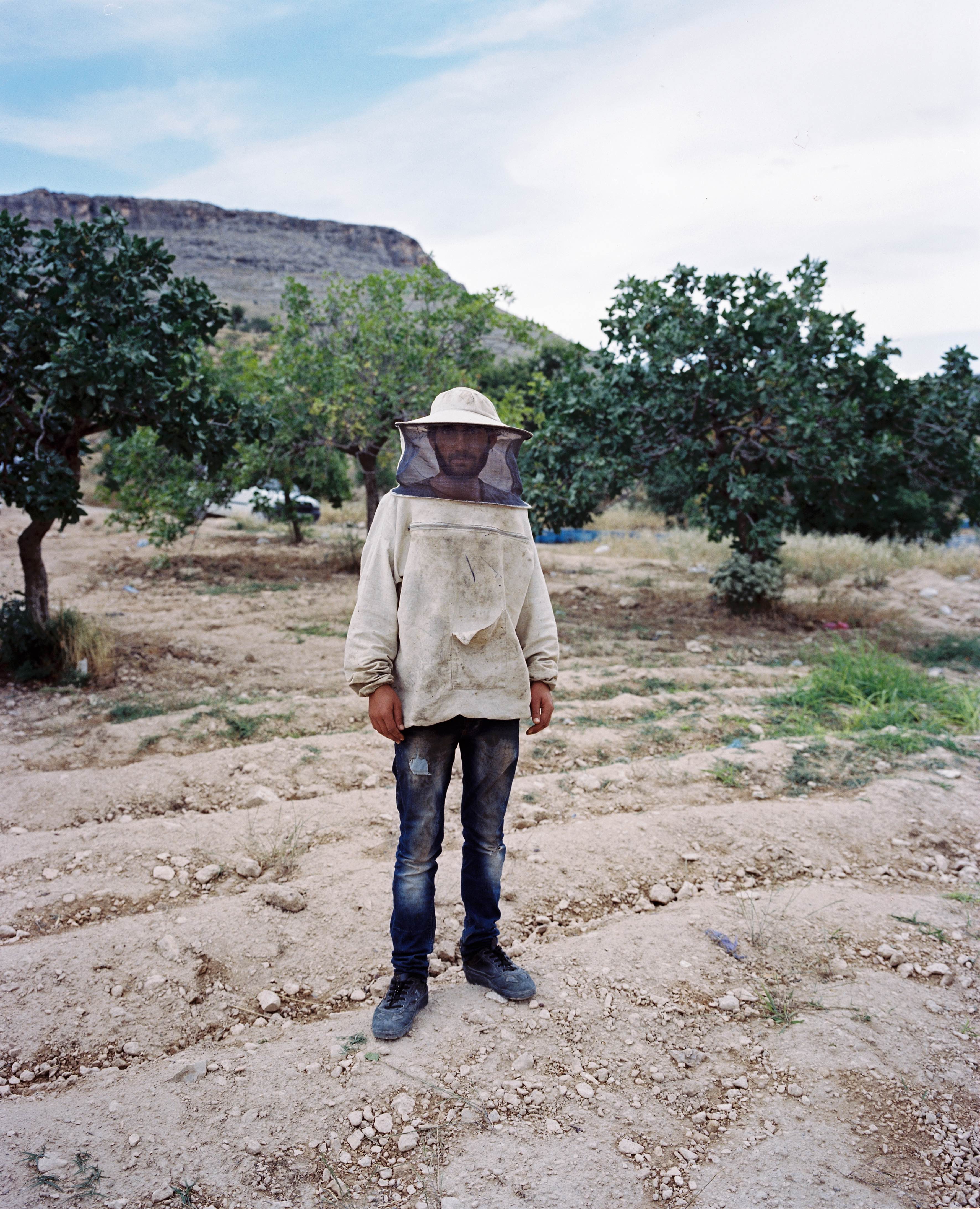 A beekeeper near the town of Halfeti, Turkey, where a flood displaced over 6,000 people in 2000.