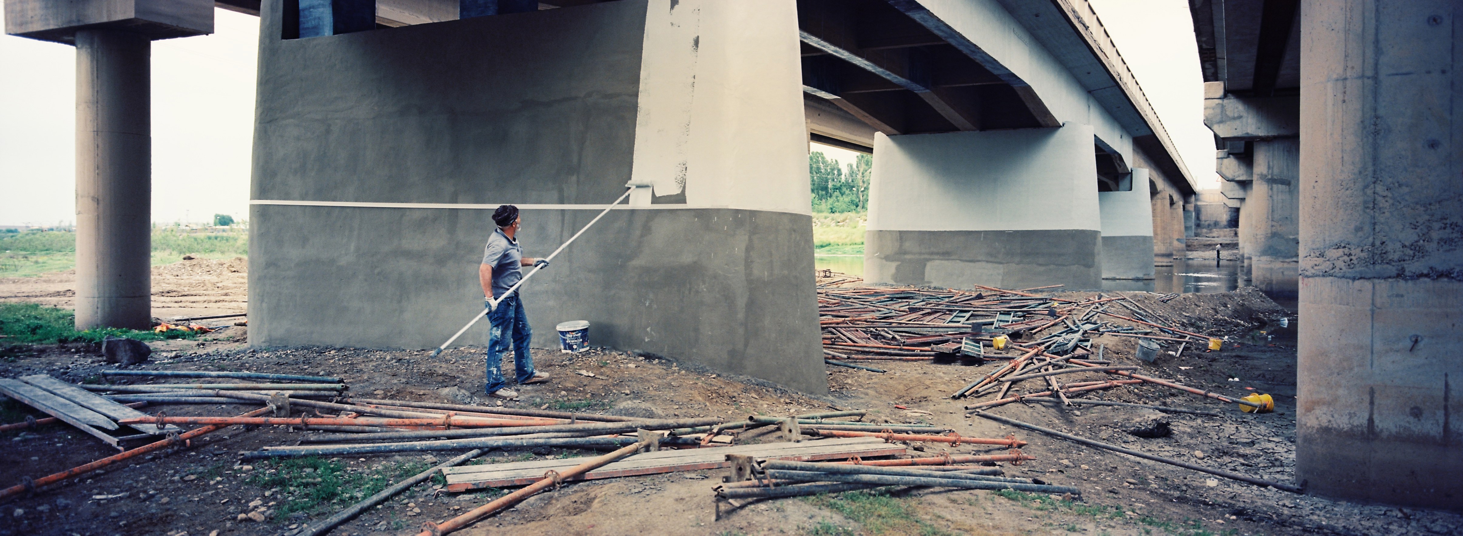 A man repaints the bridge crossing the Tigris River.