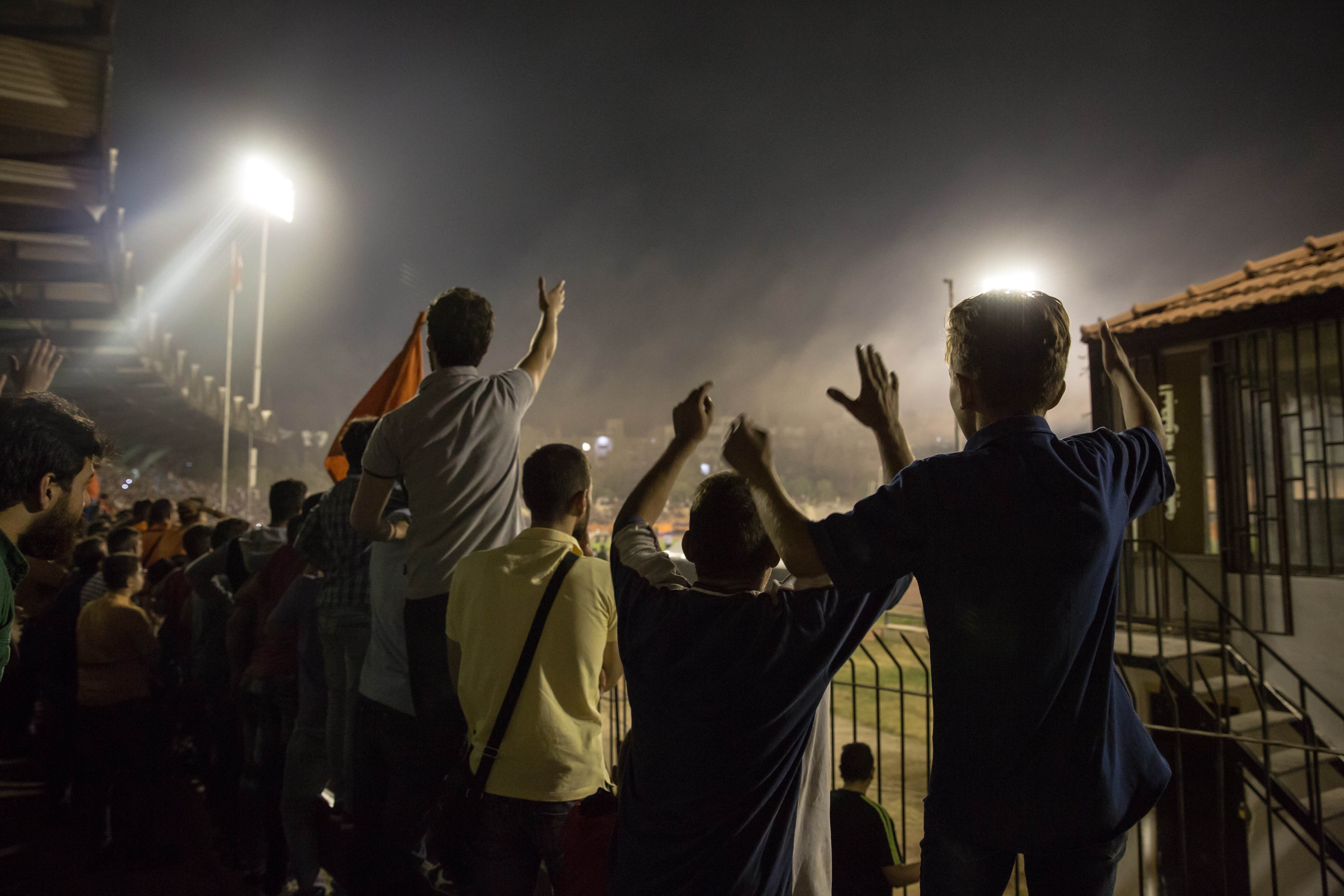 Al-Wahda fans cheer as their team gains advantage.