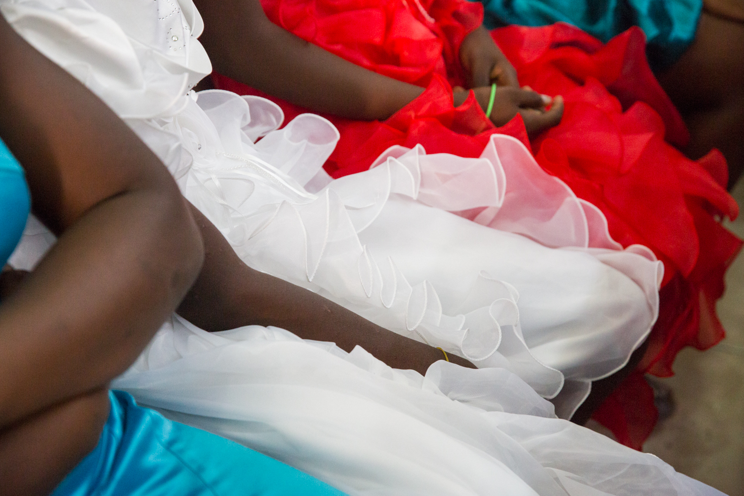 Teenage girls sitting at a pew during church service at Church sur le Rocher in Tabarre, Haiti.