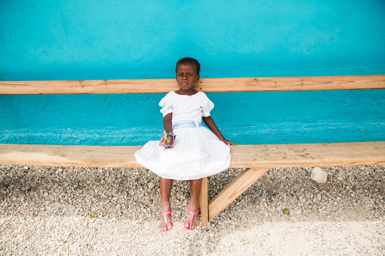 Young girl taking a break during an Easter egg hunt in Despinos, Haiti. She lives in an orphanage in Despinos, Haiti that is run by “Imagine Missions”, which houses, feeds, educates over 100 children.
